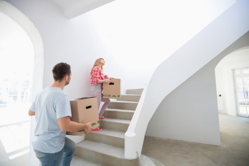 Packed moving boxes and furniture ready for flat removals in Whitecity